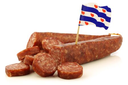 traditional frisian dried sausage pieces with a dutch flag toothpick on a white background の写真素材