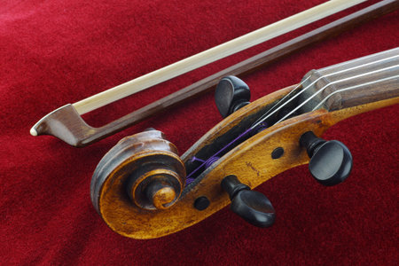 violin and bow on red background 