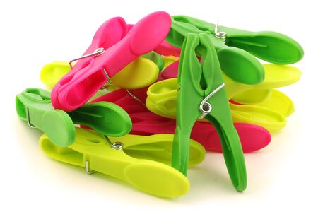 colorful bunch of clothespins on a white background の写真素材