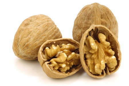 two fresh walnuts and a cracked one e on a white background の写真素材