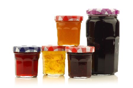 glass jars with assorted jam and marmalade with room for your label, texr or images on a white background の写真素材