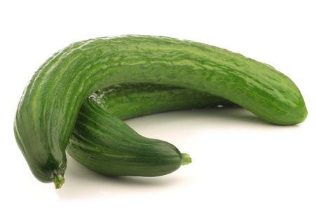 curly turkish cucumbers on a white background の写真素材