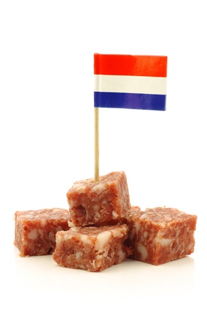 pieces of traditional dutch sausage called  boerenmetworst  with a dutch flag toothpick on a white background の写真素材