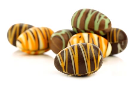 decorated chocolate easter eggs on a white background の写真素材