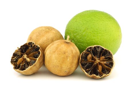 cut dried  white lime  fruit and a fresh one on a white backgroundの写真素材