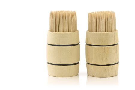 toothpicks in wooden barrels on a white background の写真素材