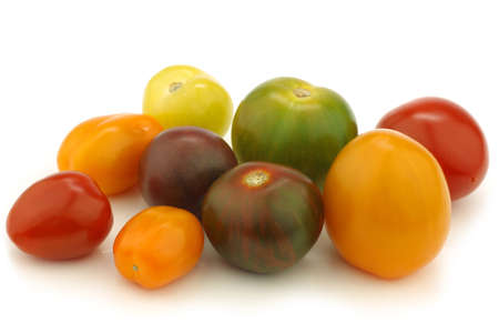 colorful display of little colorful snack tomatoes on a white background の写真素材
