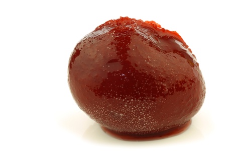 colorful red prune on syrup on a white background の写真素材