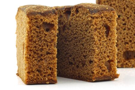 traditional dutch cut brown dessert cake  ontbijtkoek  on a white background の写真素材