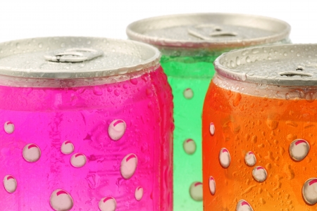 Colorful fizzy drink cans with water droplets on a white backgroundの写真素材
