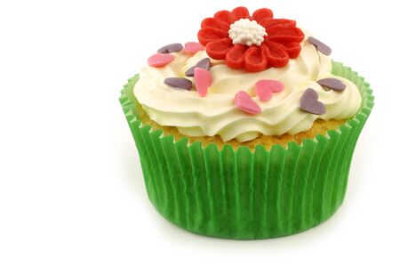 homemade cupcake with candy flower and hearts on a white background の写真素材