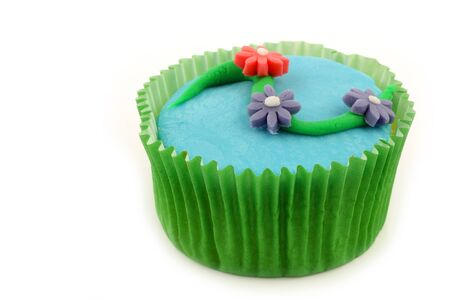 homemade cupcake with colorful flowers on a white background の写真素材