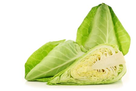 fresh green pointed cabbages and a cut one on a white backgroundの写真素材