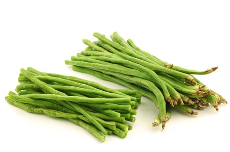 cut fresh long beans Vigna unguiculata subsp  sesquipedalis  on a white backgroundの写真素材