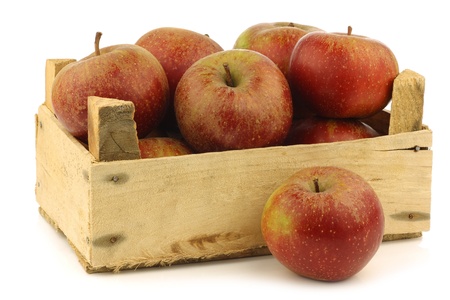 Traditional Dutch apples called  goudrenet  used for making apple pie in a wooden crate on a white backgroundの写真素材