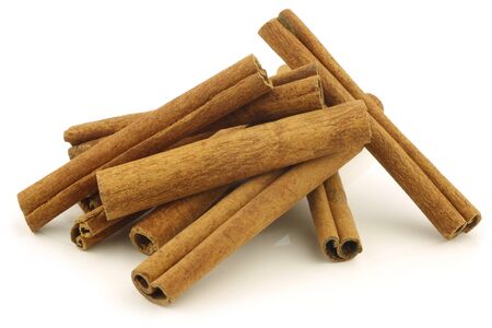 dried cinnamon sticks on a white backgroundの写真素材