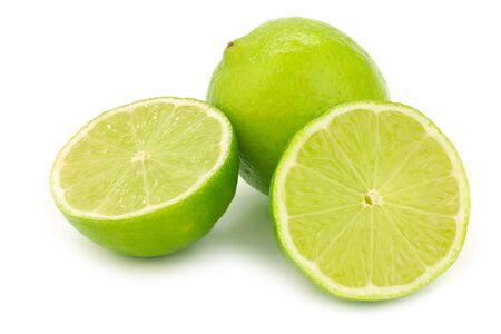 one whole lime fruit and two halves on a white backgroundの写真素材