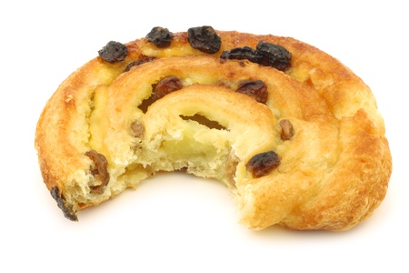 cinnamon apple roll with a bite missing on a white backgroundの写真素材