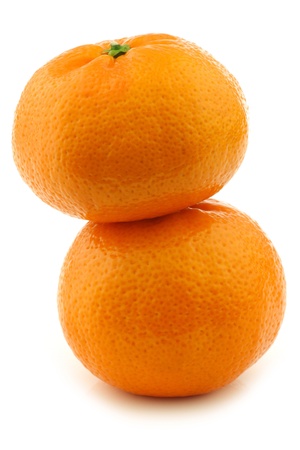 two stacked fresh tangerines on a white backgroundの写真素材