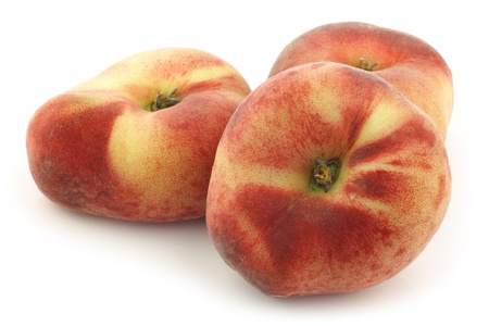 fresh colorful flat peaches  donut peaches  on a white backgroundの写真素材