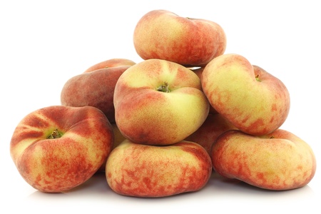  fresh colorful flat peaches  donut peaches  on a white backgroundの写真素材