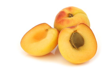fresh colorful apricot and a cut one on a white backgroundの写真素材