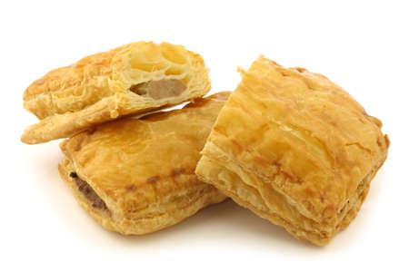 freshly baked Dutch traditional sausage roll and a cut one on a white backgroundの写真素材