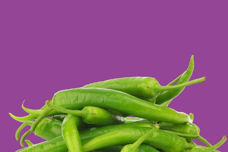 Freshly harvested jalapeno peppers on a purple backgroundの写真素材