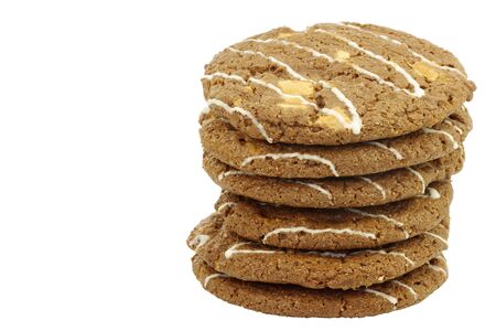 stacked crunchy chocolate chip cookies with nuts decorated with white chocolate isolated on a white backgroundの写真素材