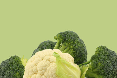Fresh cauliflower and broccoli on a green backgroundの写真素材