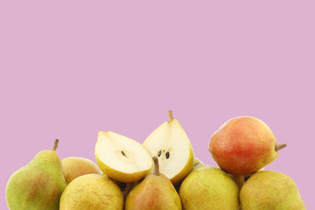 Fresh  doyenne de comice  pear and a cut one on a purple background