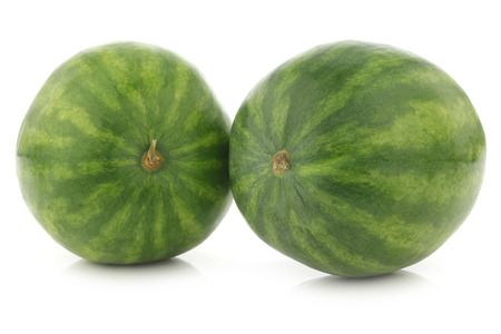 two fresh whole watermelons on a white backgroundの写真素材