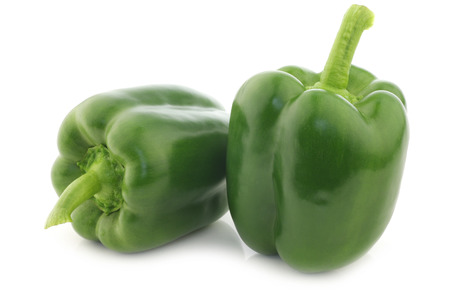 fresh green bell peppers (capsicum) on a white backgroundの写真素材