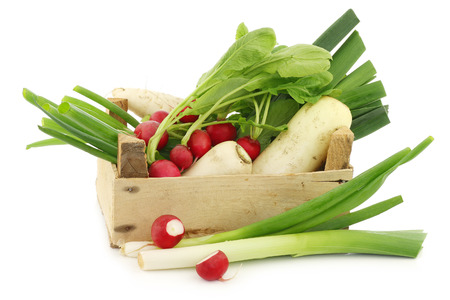 mixed vegetables in a wooden crate on a white backgroundの写真素材