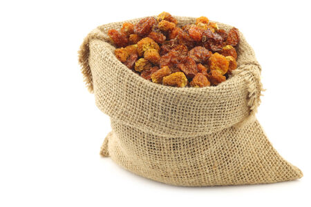 Dried Cape gooseberries (Physalis peruviana) in a burlap bag on white backgroundの写真素材