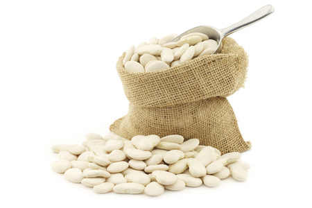 Butter beans (lima beans) in a burlap bag on a white backgroundの写真素材