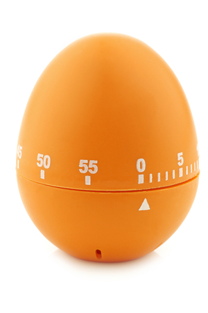 modern orange, plastic kitchen timer on a white backgroundの写真素材