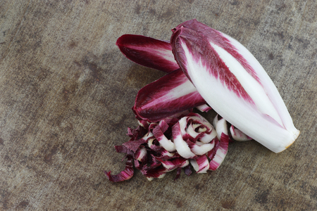 fresh red chicory on a grungy metal backgroundの写真素材