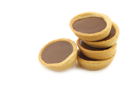 stacked caramel and chocolate filled cakes on a white backgroundの写真素材