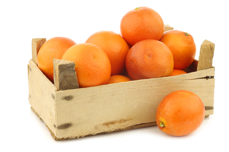 fresh blood oranges in a wooden crate on a white backgroundの写真素材