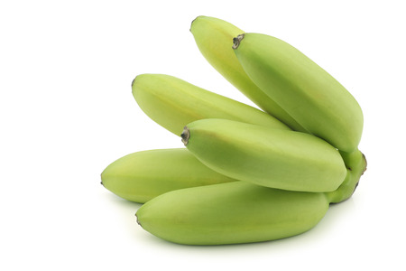 a bunch of small snack bananas on a white backgroundの写真素材