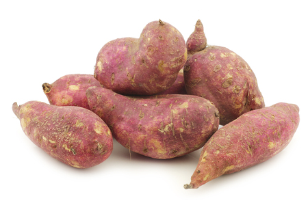 freshly harvested sweet potatoes on a white backgroundの写真素材