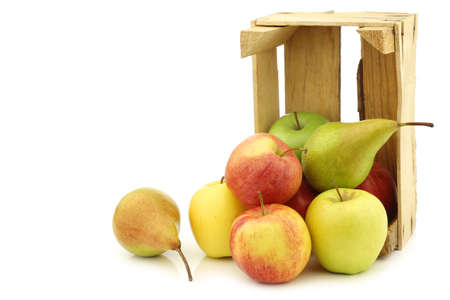 Fresh pears and apples in a wooden crate on a white backgroundの写真素材