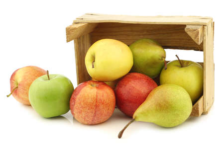 Fresh pears and apples in a wooden crate on a white backgroundの写真素材