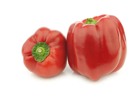 two red bell peppers (capsicum) on a white backgroundの写真素材
