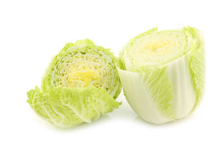 freshly cut chinese cabbage halves on a white backgroundの写真素材