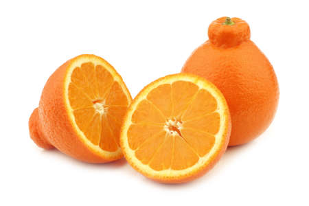 one fresh minneola and a cut one on a white backgroundの写真素材