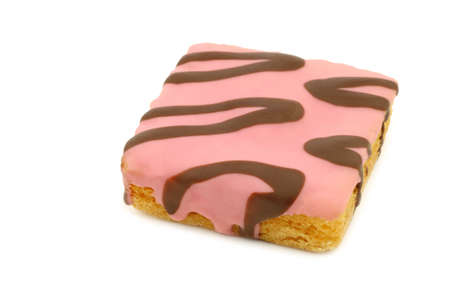 freshly baked square pink glazed cake with chocolate dressing on a white backgroundの写真素材