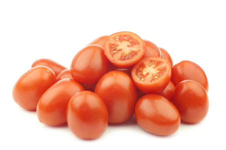 fresh and colorful italian roma tomatoes on the vine on a white backgroundの写真素材