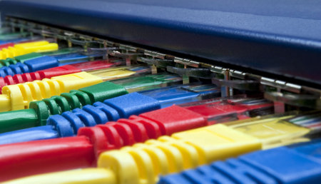 Close-up on brightly colored computer ethernet network cables connected to a router / switch